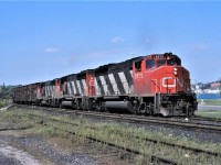 CN train 218 takes the siding at Barrie, Ontario for a meet with the northbound Super Continental.  Normal power for most trains at that time, but a somewhat abnormal routing for 218 going down the Newmarket Sub. Power for 218 was 9579 9590 and 9545.  Unfortunately, the track shown here is just history.
