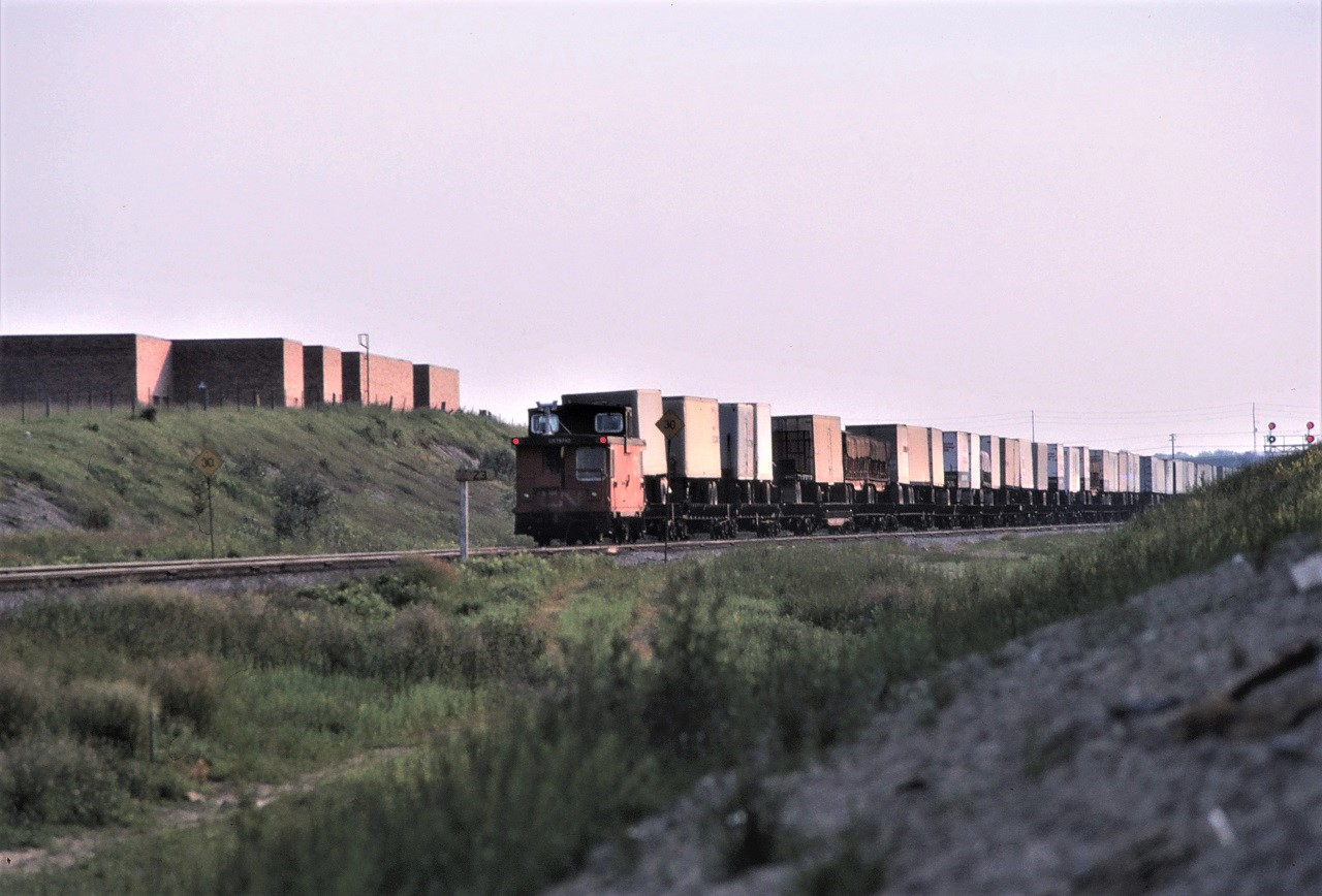 CN train 218 has pulled into Toronto (MacMillan) Yard, dropped the head end cars in the yard, backed out on the York Sub, and prepares to take the piggyback cars to the new intermodal yard in Brampton.  They have just received their signal to proceed.