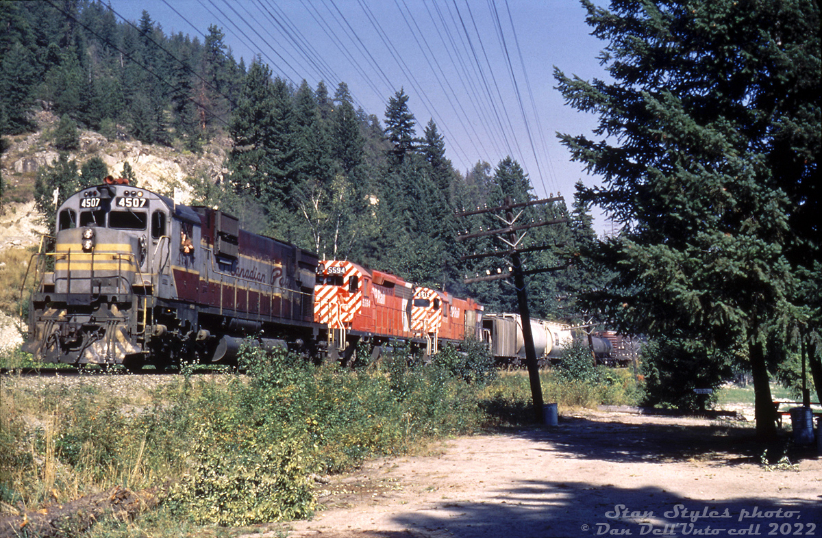For its high horsepower second generation 6-axle power needs out west, CP looked to two builders' offerings in the mid-60's: first acquiring a group of 65 SD40 units from GMD, and later sampling 8 C630M's from MLW. Due to reliability problems with the SD40 fleet, CP looked to MLW to dieselize its coal train operations out west with an army of Locotrol-equipped M630's (and M636's for general freight use, mostly in the east).

But, CP eventually went back to GMD once the new SD40-2 model came out that solved reliability issues with the earlier 40's, and reliability issues with the M630's operating out west came to light. The SD40-2 became CP's standard mainline power on coal and grain trains out west for decades, and most of the MLW 6-axle units were "banished to the east" (as some would say) during the mid-70's.

Here, in a sort of transition period, we see CP C630M 4507 (in tattered maroon and grey paint) leading brand new CP SD40-2 5594, and M630 4512 on a manifest freight past a small park area in Glen Echo BC, sometime in 1972-1973. Both builder's models would operate together for a while, until CP loaded up on SD40-2's and had the 5800-series purchased and set up as Locotrol Master units.

Stan F. Styles photo, Dan Dell'Unto collection slide (duplicate).