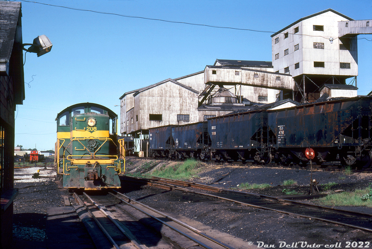 When most people think Alco in Canada, they might think of Ontario Southland's collection, Cartier's fleet of big M's, VIA's passenger FPA4's, or the large fleets run by CN and CP, but a lot of secondhand Alcos migrated up from the states in the 60's-80's to shortlines, regionals and industrial operations.

Devco Railway of Glace Bay NS (formerly Sydney & Louisburg) acquired about a dozen secondhand Alco RS1 locomotives from Minneapolis & St. Louis and SOO Line in the early 60's, that served as their primary diesel power unit newer power (including GMD GP38-2's) sidelined most of them in the 80's. Here, Devco RS1 208 sits next to the coal tipple in Sydney Mines, NS in 1982. The two bay coal hoppers are lettered for DR and DRXX.

Devco RS1 208 began life as Minneapolis & St. Louis 946, built by Alco in August 1946, then renumbered 217, sold to S&L as their 208 in 1960, then becoming Devco 208. The unit was sold to Salem & Hillsborough in 1984 as their 8208, but was lost in their arson fire in 1994.

Original photographer unknown, Dan Dell'Unto collection slide.