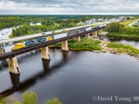 Hearst bound with bridge traffic for the CN at Hearst along with a handful of cars for the local industries, Ontario Northland SD40-2's 1733 and 1734 are in charge of a 29 car consist crossing over the Missinaibi River at Mattice, Ontario.