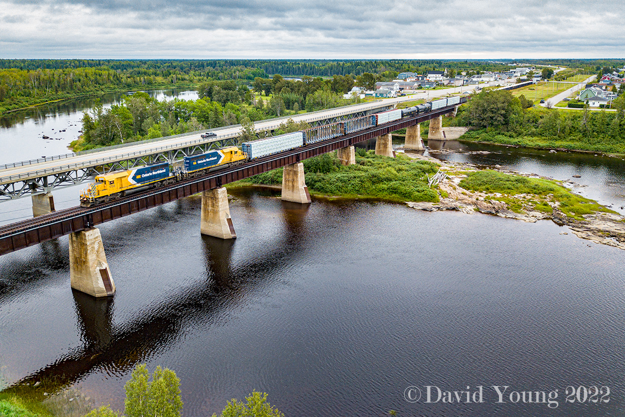 Hearst bound with bridge traffic for the CN at Hearst along with a handful of cars for the local industries, Ontario Northland SD40-2's 1733 and 1734 are in charge of a 29 car consist crossing over the Missinaibi River at Mattice, Ontario.