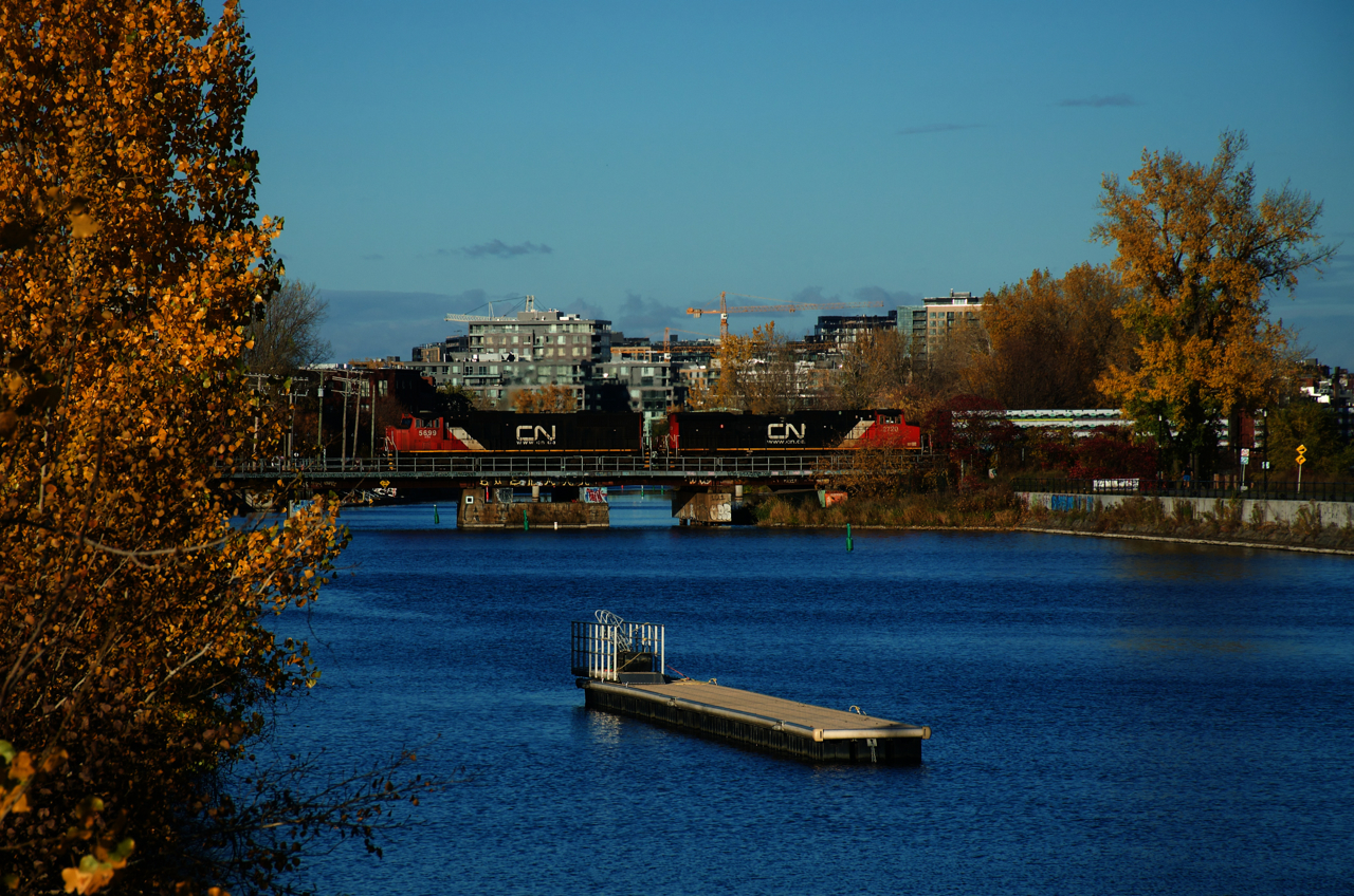 After holding on the Butler spur, CN 401 is on the move and crossing the Lachine Canal with CN 5699 & IC 2720 for power.