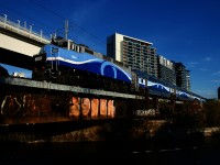 AMT 1340 pushes a 4-car EXO 809 from Mont-Saint-Hilaire over the Lachine Canal. At left is the tracks for the REM light rail line. This section of the REM is supposed to open in December.