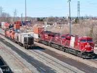 Eastbound Vancouver to Toronto intermodal 110-07 arrives at Westfort with CP 8876 - CP 9582 - CP 8553 leading. CP 8876 sports the 2010 Vancouver Olympic paint scheme, one of 20 ES44AC locomotives (CP 8858-8877) painted in this special scheme to commemorate the 2010 Winter Olympics. Soon after the 2010 Olympic flame was extinguished all the units were returned to the current Canadian Pacific block stencil. All except the 8876 which continues to roam the system with the bare white slash on its flanks with the small Canadian Pacific red print remaining. Any trace of the 2010 Vancouver insignia has been painted over. The Current River triple set having hauled two empties from the Richardson's elevator, is seen parked in track A1 while their crew has their lunch in the nearby "Westfort shack". Power was CP GP9u's CP 1633-CP 1571-CP 1694.