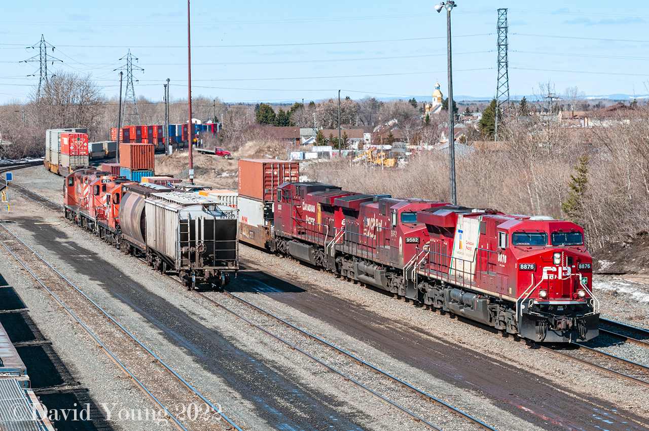 Eastbound Vancouver to Toronto intermodal 110-07 arrives at Westfort with CP 8876 - CP 9582 - CP 8553 leading. CP 8876 sports the 2010 Vancouver Olympic paint scheme, one of 20 ES44AC locomotives (CP 8858-8877) painted in this special scheme to commemorate the 2010 Winter Olympics. Soon after the 2010 Olympic flame was extinguished all the units were returned to the current Canadian Pacific block stencil. All except the 8876 which continues to roam the system with the bare white slash on its flanks with the small Canadian Pacific red print remaining. Any trace of the 2010 Vancouver insignia has been painted over. The Current River triple set having hauled two empties from the Richardson's elevator, is seen parked in track A1 while their crew has their lunch in the nearby "Westfort shack". Power was CP GP9u's CP 1633-CP 1571-CP 1694.