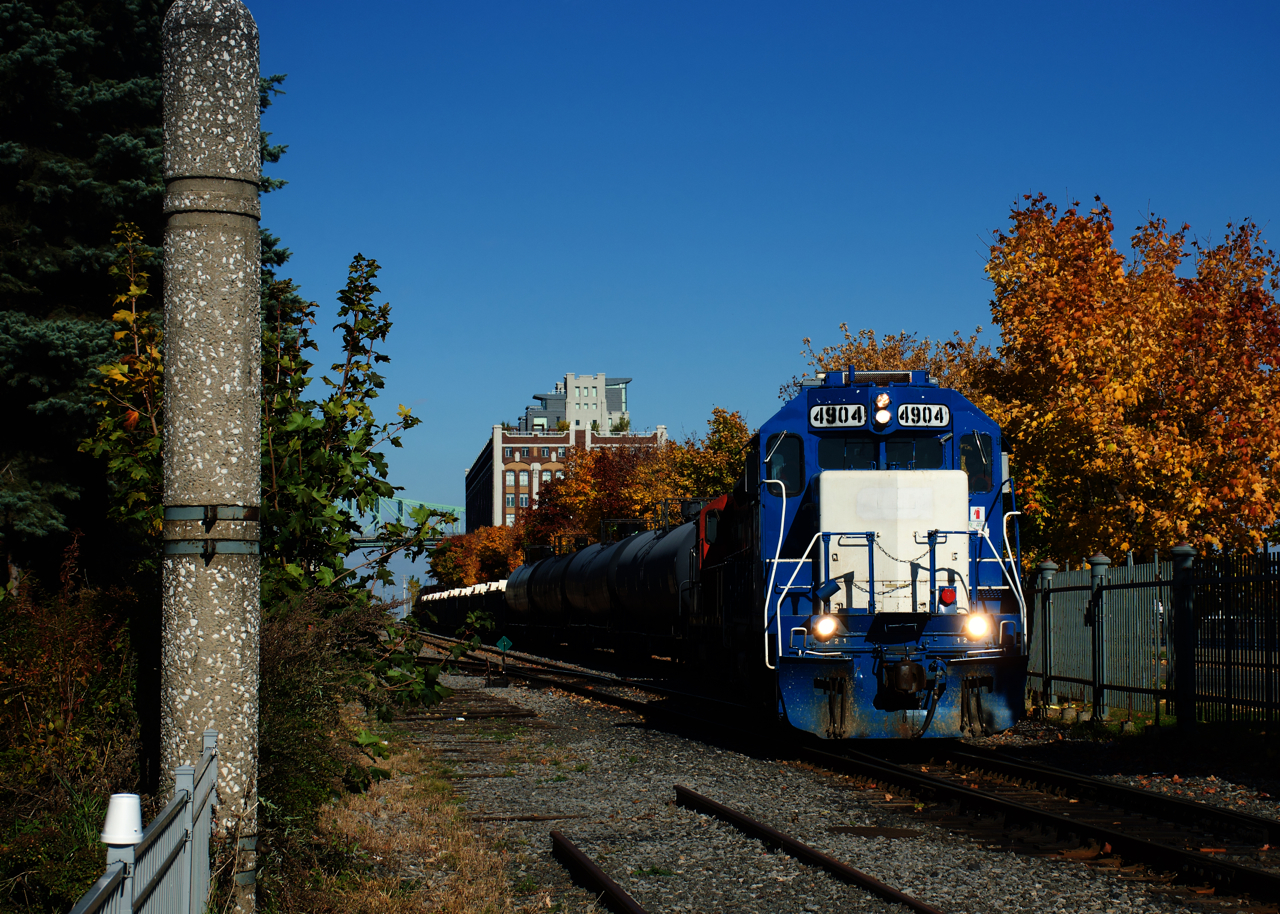The Pointe St-Charles Switcher is starting to leave the Port of Montreal with a short cut of cars as it passes some fall colours. Power is CN 4904 & CN 7060.
