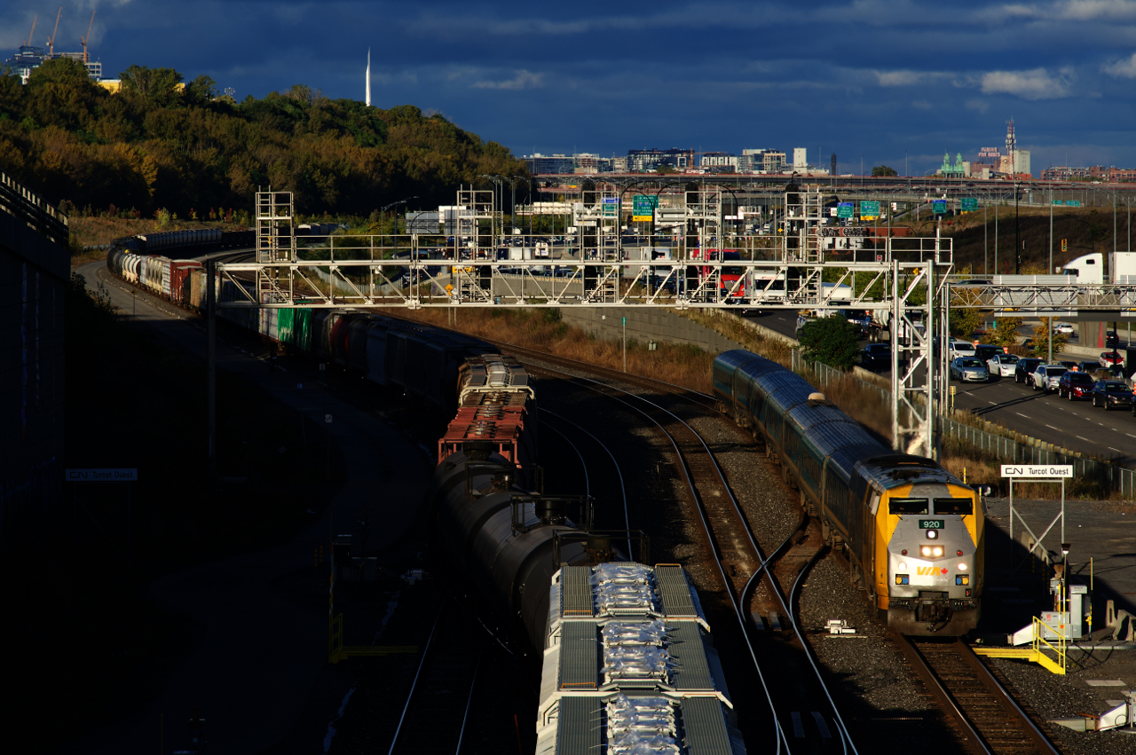 VIA 37 with VIA 920 and a Renaissance consist is passing Turcot Ouest. At left CN 596 is backing cars onto Track 29 as it finishes building a CN X321.
