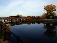 CN 401 with CN 3855 & CN 3918 is reflected in the unusually still waters of the Lachine Canal as it heads west on a bit of a hazey afternoon.