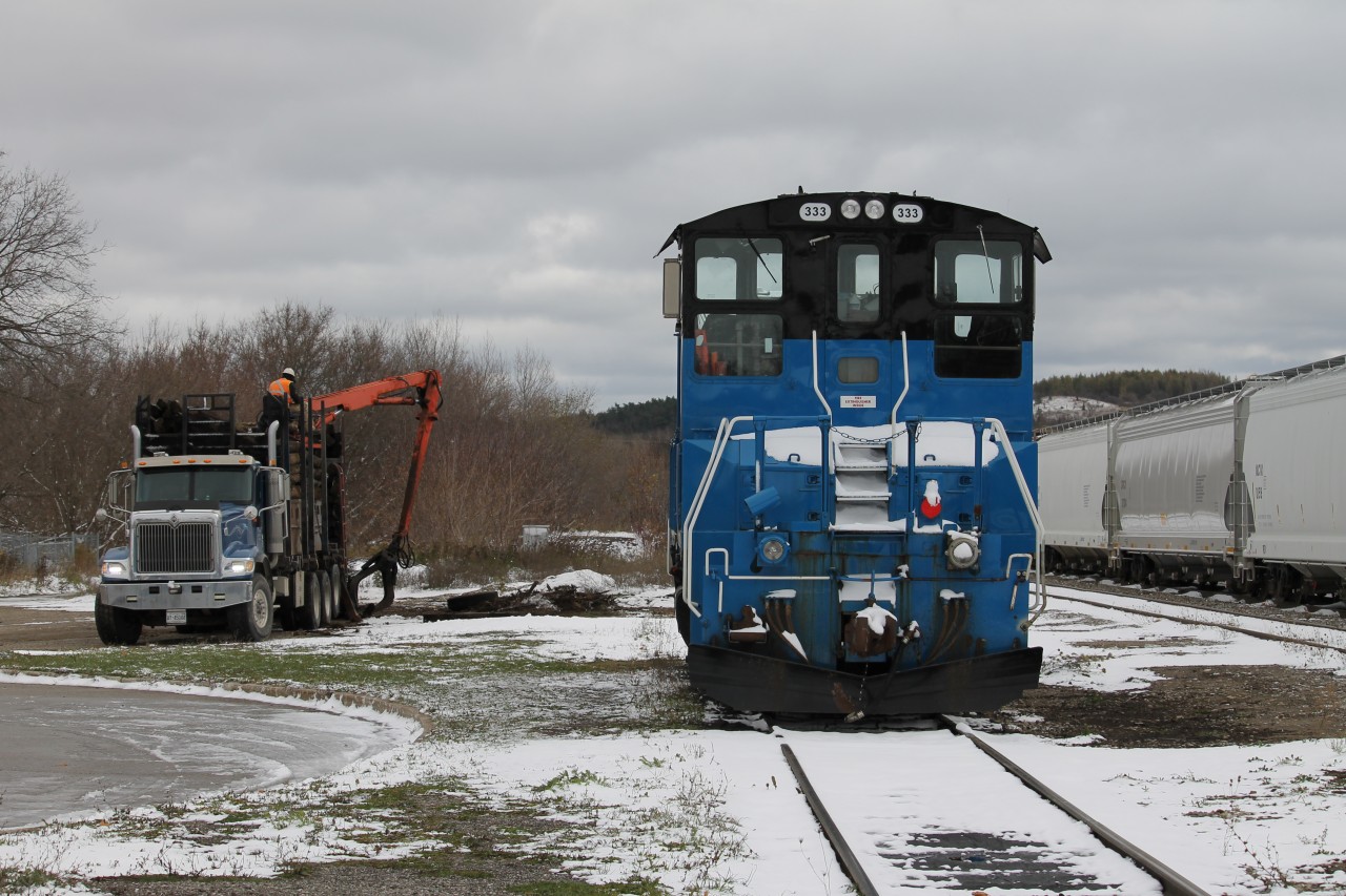 GMTX 333 sits locked up in the yard at Orangeville, two tracks full of hoppers, maybe plastic pellets destined for Clorox, a contractor tidies up old ties. This sure looks like a viable railway to me. Who would think that in a little more than 12 month the end would come.