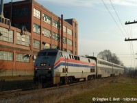 VIA 85 blasts out of Kitchener with Amtrak 29 in the lead passing the <a href= http://www.railpictures.ca/?attachment_id=20495 target=_blank>Airboss factory</a> which had rail service until CN took over. I only had two to three weeks to photograph this train with my good camera after getting it in March 2004 and I pretty much photographed it every work day as I followed the train into town.

Airboss no longer has rail service, but back in the day they got both CN and CP service (Grand River Railway, would have also been electric!) as the CP/GRR underpass with CNR was at the west end of the factory.

