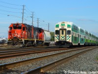 A GO transit eastbound blasts by L554 with a single sugar hopper in tow from Lantic at Mimico, about to lift their cars in the yard and head to Aldershot.