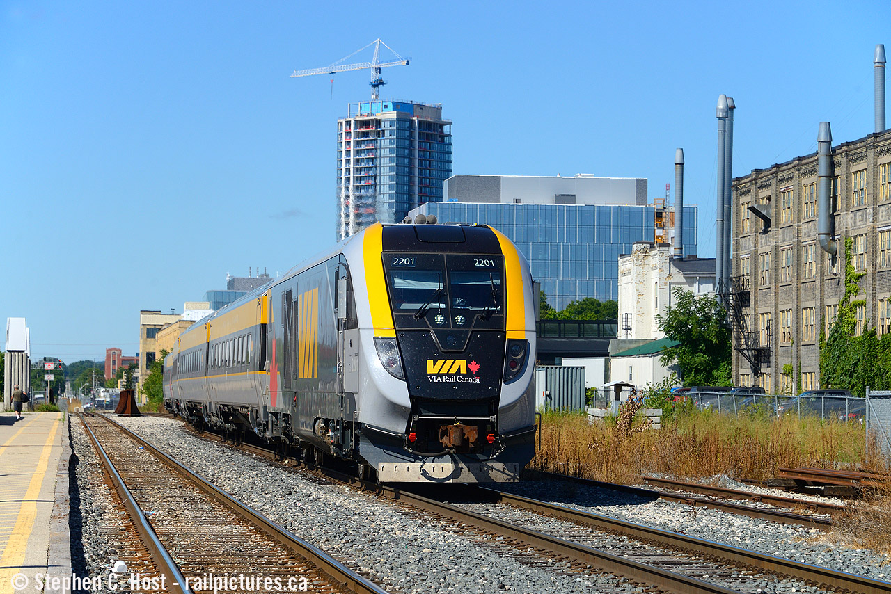VIA 688 pauses on the siding at the Kitchener VIA station with the classic Krug furniture factory (opened 1898, still in production) and Google BRT2 in the background. What changes to this scene over the last 10 years.