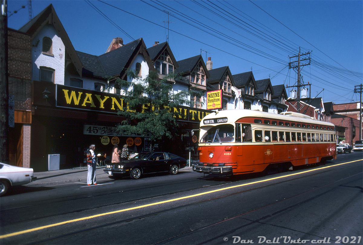 TTC PCC 4384 operates on an eastbound Carlton run, diverting southbound over Parliament Street between Carlton and Gerrard. The streetcar is passing a row of Victorian-era houses home to Wayne Furniture, at the time celebrating its 45th birthday.

From some research online, it appears Wayne Furniture stated off selling Radios as the Wayne Radio Company at 446 Parliament Street in 1944. It was opened by Max Wainberg and his sons, and operated through three generations of the family. Other information on the business is hard to find, but it appears they may have closed down sometime in the 90's or early 2000's.

Original photographer unknown, Dan Dell'Unto collection slide.