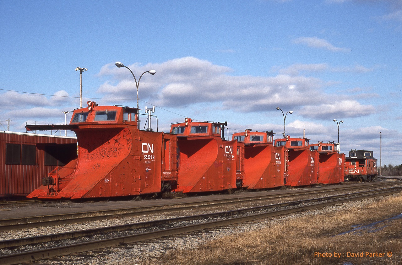 Looking out the window here in Welland at at least a foot of snow today (Nov 19th 2022) We sure would love to see some of these out on the tracks.  Five CN Plows 55209-55267-55400-55241-55xxx and a van await some snow at Gordon Yard in Moncton NB on Jan 22nd 1996.