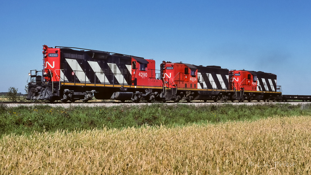 Not only were f-units becoming hard to find in the summer of 1988, trios of GP9's also became hard subjects to photograph. There will be just a few more occurrences of GP9 trios between this date and May/89 when it came to an end. June 1989 saw a major share of railroading go to GP38's. On occasion, the re-built 4100's (infrequent) and 4000's (common) would be seen on trains. Two years later in Aug./90, I photo'd my last train on the Coronado. With over 90% of trains with GP38's, they all looked the same. The extra in this photo is just north of Edmonton at mile 6.7 at 11:30. It was nice having the rare visitor 4604 in the consist.