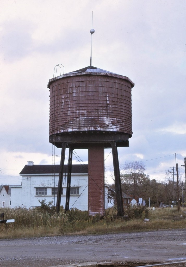 CN's old wooden and leaky water tank at Washago, Ontario as seen on October 11, 1971.  Mileage could also be indicated as Mile 98.8 Newmarket Sub.