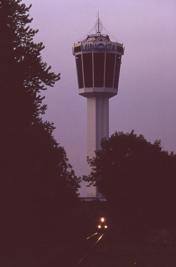 Some days, when waiting out a train and the sun is going down, you know it is coming so you just wait it out. This is a case of a nice warm summer night..and I am hanging around at the South Siding Switch, Montrose, because I KNOW this train is out there somewhere. And close. Alas, the sun went down and I was left with this effort. Pity I did not record the lead unit; only that I thought this was CP train #521.........but it could have been 523, or........

The Minolta Tower, plain to see in this image, is now surrounded by high-rise hotels as Niagara Falls continued to boom with the tourist trade.  I believe the structure is now referred to as the Tower Hotel. Tracks thru Niagara Falls tourist area were removed around 2001.