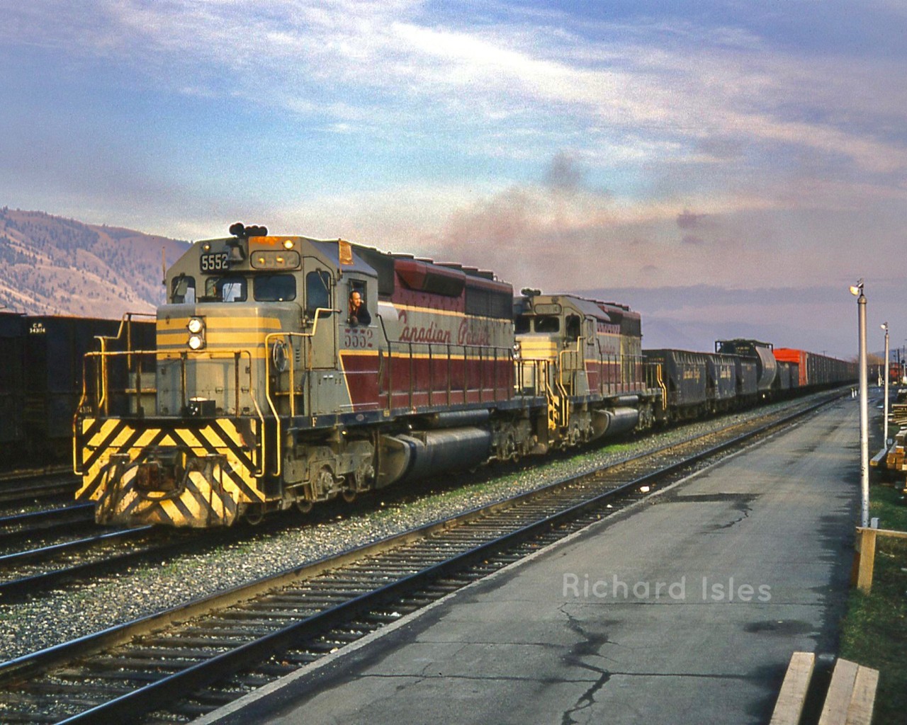 Canadian Pacific Railway GMD SD40s in the wine and grey script paint scheme. CPR 5552+5543 is leaving as a Westbound Extra at Kamloops British Columbia ????????, Shuswap Sub. on October 25, 1969.