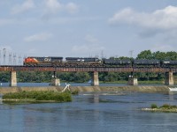 With a 10mph speed restriction in place due to the heat, and some foreign power trailing, CN L502 makes its way down the branch to Garnet Yard slowly crossing the Grand River at Caledonia.