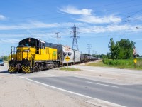 In a rather impressive display of EMD muscle, a lone GP9 lugs 50+ cars of manifest towards ETR Ojibway Yard on a sunny July morning in the south end of Windsor. Once at Ojibway, the train will be disassembled and individual cars will be delivered to customers in the area.