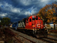 The sun holds out just long enough to get a sunny shot of CN 4712 & CN 4904 leaving the Port of Montreal with a transfer as a bit of foliage remains.