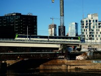 An REM (Réseau express métropolitain) test run crosses the Lachine Canal on its way to Central Station. While this section of the REM light rail line was supposed to open this November, it has now been pushed back to early 2023. This section of the REM parallels the CN St-Hyacinthe Sub. Directly behind the train but completely obscured is Wellington tower, which was in use to control the interlocking around here into the early 2000s. 'Wellington' is still a control point on the St-Hyacinthe Sub.