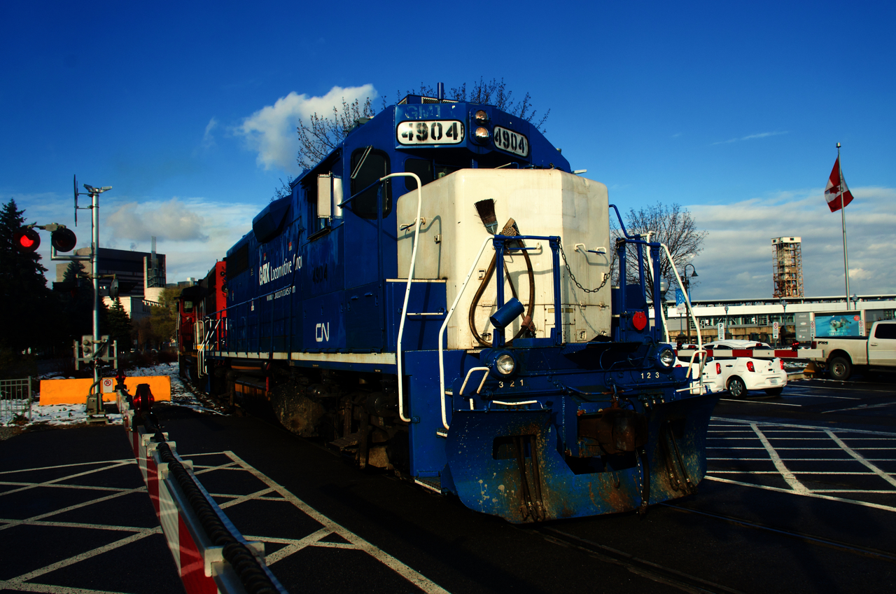 The Pointe St-Charles Switcher is passing one of the many crossings in the Port of Montreal as it heads back to the yard. Up until a few years back these crossings were all manually flagged by port security.