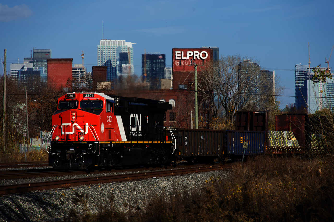 Only in use a bit over a week since being released into service after being rebuilt, gleaming CN 3301 leads CN 305 past the skyline of downtown Montreal. CN 3301 was formerly Dash9-44CW CN 2591 and was rebuilt into a AC44C6M at Wabtec's Fort Worth plant.