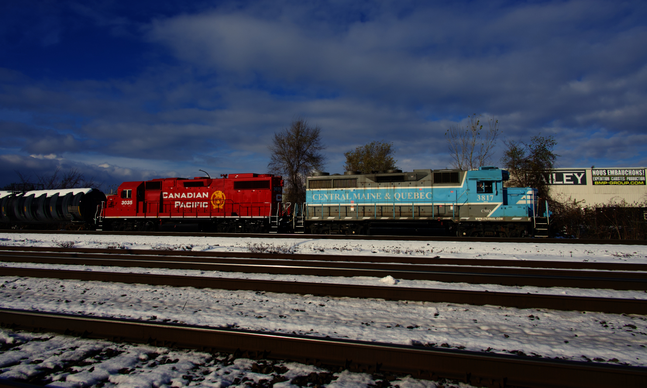 CP G95 has CMQ 3817 & CP 3035 for power as it switches out Dural, one of a handful of clients still served by CP in the Montreal area. In the foreground is CN's Montreal Sub, triple tracked here.