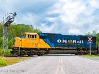 Framed amongst the crossing and old cantilever ABS signals at the south switch Jardine, ONT 2104 South pauses on top of Highway 640 for a brief moment as the crew couples up to their remaining train. Having finished up their switching moves setting off Noranda bound loads of copper concentrate ex Kidd Creek to the north end of Jardine, they will pull down then back into the siding to clear for a meet with Rouyn-Noranda bound train 211.