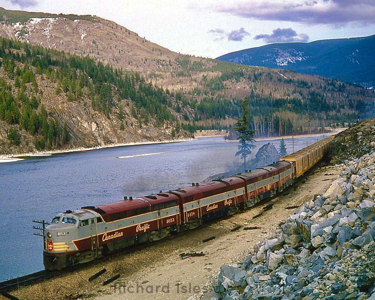 CP 4053+4058+4472+4105 (freight version of Fairbanks-Morse cab unit (CLC CFA16-4) are hauling freight train #87, going from Nelson to Trail along Kootenay Lake.  At this view point along the highway, they are Westbound, Mile 2.8, between #Nelson and Taghum, Columbia Sub. British Columbia on May 28, 1970.
