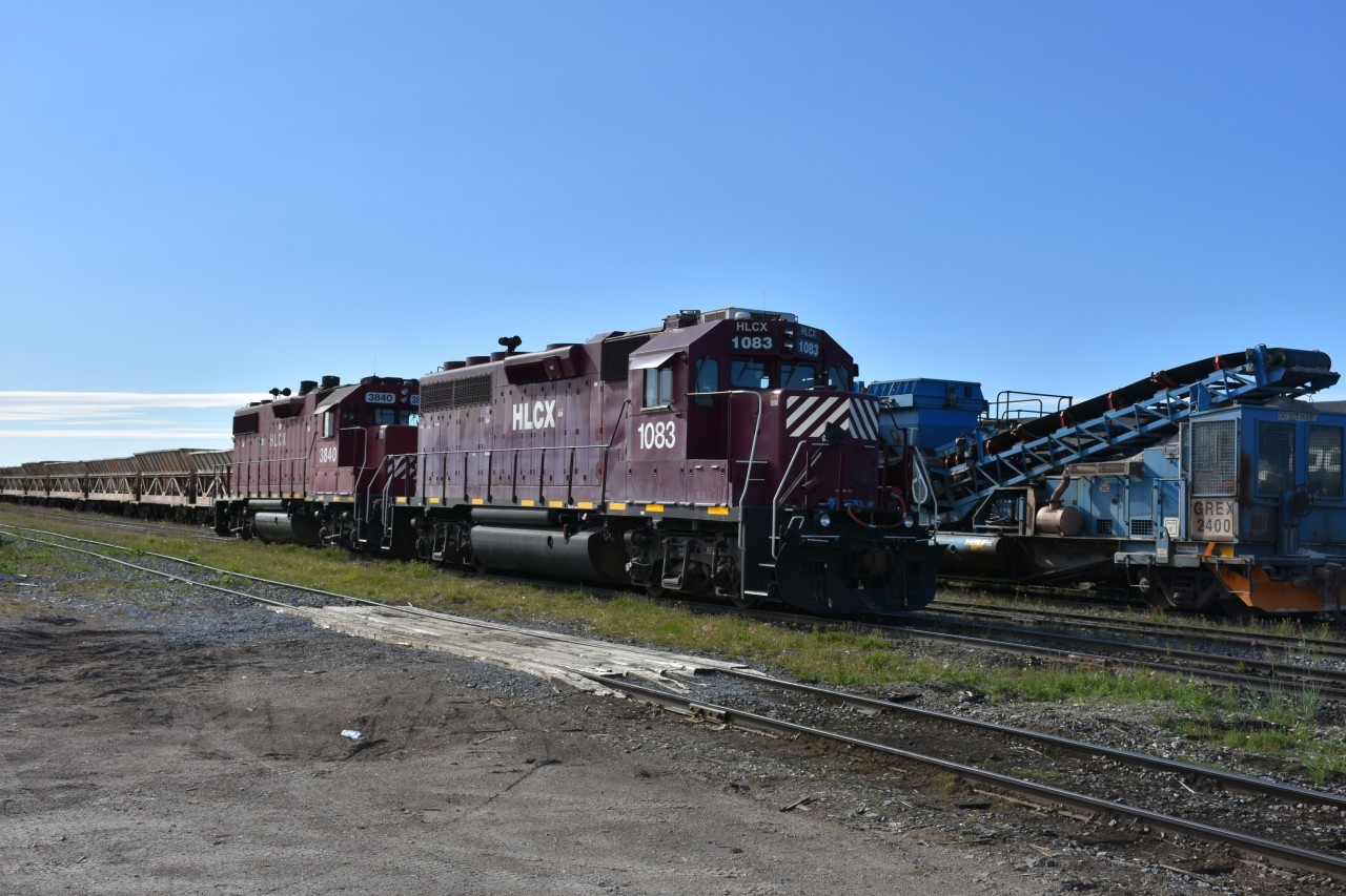 Hudson Bay Railway units HLCX 1083 & HLCX 3840 are shut down in the yard at Churchill, MB next to GREX 2400 material distribution train. All are awaiting their next assignment which is not far off in this busy terminal.
