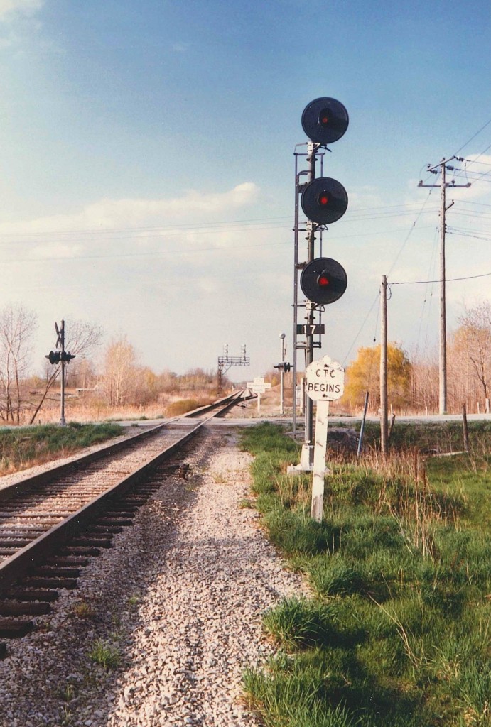 On The Humberstone - 1986.  Looking north to the double track section of the CTC controlled Humberstone Sub.  Up until the end of '87 both CN and TH&B used the tracks here.  It was not uncommon for TH&B's trains leaving town to be stranded down at Nickel Yard until they got CTC clearance. All the CTC was gone here by 1988, and the double track section reduced to a single line.  Today, the rarely used (but well maintained) line has been demoted to the Humberstone Spur, serving VALE, and the odd other technical move (JTL, Transformers, etc).  The Humberstone dates from the late 1850's as the southern portion of the WELLAND RAILWAY that joined Port Colborne (Lake Erie) and Port Dalhousie (Lake Ontario).