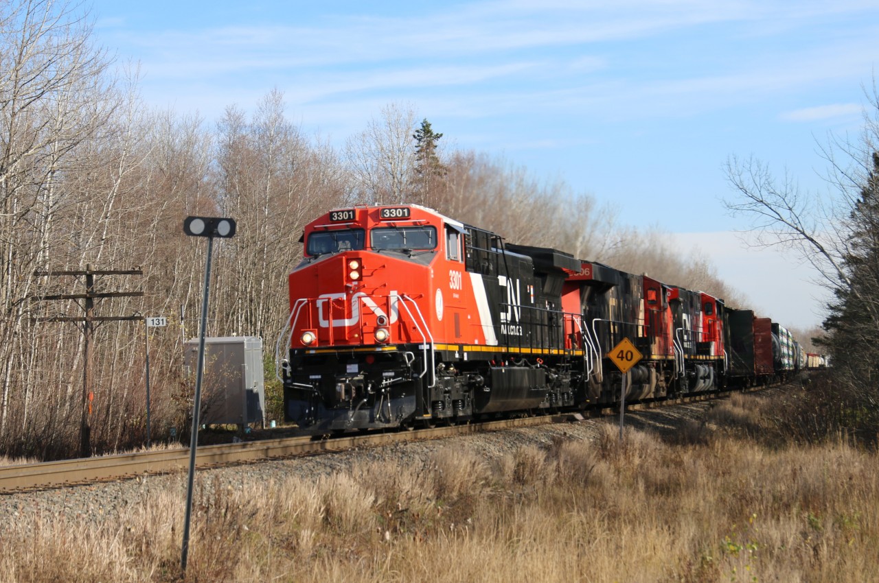Newly rebuilt AC44C6M, 3301 leads train 305 out of Moncton's Gordon Yard along with ES44AC 3806 and AC44C6M 3300 all on the head end.