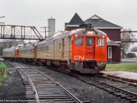 <b>Last CN Passenger service at Palmerston, part 3.</b>  Three CN railiners meet on the Newton Sub platform at Palmerston, preparing to go their separate ways for the final time.  In the middle, an RDC-1 from Owen Sound (formerly train 672) was the first to arrive at 0655h, followed by RDC-1 6118 from Kincardine at 0700h (formerly train 662, furthest from the camera).  The final movement to arrive at 0705h, RDC-2 6354 from Southampton (formerly train 668), has been added to the front of the Owen Sound car awaiting departure.  In just a few minutes at 0715, passenger service will cease as Extra 6354 departs for Toronto via Guelph (former train 658) and Extra 6118 departs for Stratford (former train 663).<br><br><i>John Freyseng Photo, David Warne Collection slide.</i>