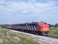 Led by a classic A-B-A set of covered wagons, CN's Nanticoke steel train approaches Stelco's Lake Erie Works.  Late summer 1986 kept photographers occupied with this train as the days of the F7s were waning.  Most shots on this site past September 1986 include GP9s in the consist:<br><br>August 26: <a href=http://www.railpictures.ca/?attachment_id=44559>Climbing the hill through Dundas,</a> Arnold Mooney<br>August 29: <a href=http://www.railpictures.ca/?attachment_id=7730>Mile 1 Dundas,</a> Arnold Mooney<br>August 30: <a href=http://www.railpictures.ca/?attachment_id=47437>At Hamilton Shops,</a> Photographer Unknown<br>September 2: <a href=http://www.railpictures.ca/?attachment_id=14110>Mile 1 Dundas, </a> Arnold Mooney<br><br><i>James P. Marcus Photo, Jacob Patterson Collection Slide.</i>