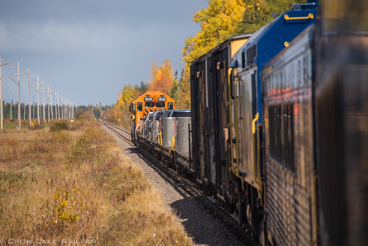 Ontario Northland's Polar Express heads to the remote northern village of Moosenee. It is only accessible by rail and plane in the summer until the lakes freeze to make roads. Just behind #ONR1808 painted in an Every Child Matters scheme are some automobiles loaded on flatcars.