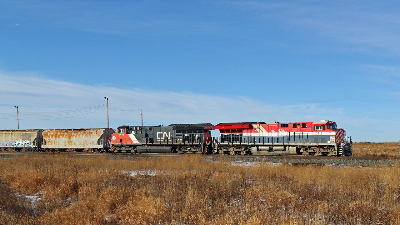 CN 3115 in heritage BC Rail "hockey stick" livery waits to depart Scotford yard eastward.