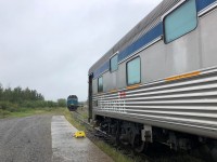 It's pouring rain in Thompson, MB on this dreary August day but, with a photo op calling I stepped off my sleeper VIA 8229 Chateau Viger on the tail end of VIA #692 (Churchill to Winnipeg), to snap VIA #693 (Winnipeg to Churchill) headed up by VIA 6443 which had backed up the Thompson Sub. just minutes ahead of us. The two passenger trains sat about one car length apart, with VIA #692 in front of the station building.