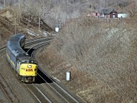 It may not look all that bad from my perch inside the old Canada Crushed Stone conveyor overhang that used to be at mile 4 on the Dundas sub; but I was open to the wind and was freezing my buns off. After all, this IS December. An eastbound VIA 6786 is photographed rounding the bend after passing the old CN Dundas station, visible in the top right. The demolition of the conveyor structure over the tracks in 1986 put an end to this angle forever.