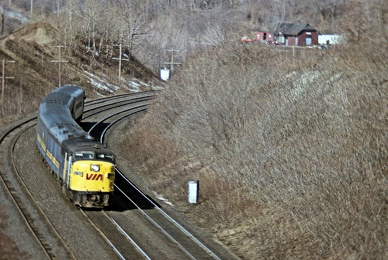 It may not look all that bad from my perch inside the old Canada Crushed Stone conveyor overhang that used to be at mile 4 on the Dundas sub; but I was open to the wind and was freezing my buns off. After all, this IS December. An eastbound VIA 6786 is photographed rounding the bend after passing the old CN Dundas station, visible in the top right. The demolition of the conveyor structure over the tracks in 1986 put an end to this angle forever.