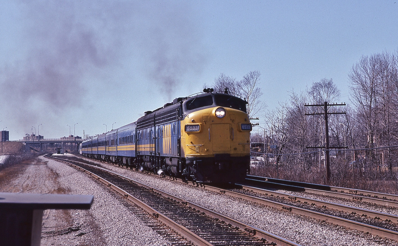 After the station stop....
 

   VIA #62  Rapido with FP9A #6533 accelerates away.... 


 At CN Guildwood mile 321 Kingston Sub, May 13, 1983 Kodachrome by S.Danko
 

   Noteworthy
 

   the jointed rail supported the 90 m.p.h. Speed Limit (95 m.p.h.  for  LRC)
 

  and on the 62's tail end a new LRC car on a test run.
 

  in the foreground at left, a new yet to be installed track switch heater


   and oh! Look at how GO Transit was so much simpler prior to the Mega expenseLinx (Metrolinx) !


   more:
 

       at the Golf Club  
 

sdfourty