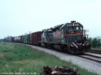 An Eastbound CSX train rolling through Shedden, ON behind a pair of Seaboard System SD40-2's 8109, and 8214 on May 30th, 1987. 8109 was built as L&N 8109 in May of 1980, and would go on to become CSXT 8109 before being retired sometime in the 2010's. 8214 was built as L&N 3586 in September 1977, and is presently still on roster as CSXT 8214