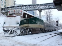 The daily Amtrak Cascades train is pictured passing the Sapperton Skytrain Station in the New Westminster area of Vancouver after an infrequent heavy snowfall. Supposedly, this unit is a baggage car and the lead unit is WSDOT 1404, which appeared to be a Siemans Charger unit. WSDOT stands for Washington State Department of Transportation. 