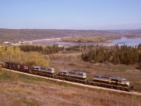 The homeward-bound (southward) GSL Turn on Saturday 1980-09-27 is shown making excellent use of the dynamic braking on SD38-2 units 402 + 403 + 401 at mileage 50.5 as they descend the grade approaching the Peace River crossing and town of the same name, a perfect match of machine and task.