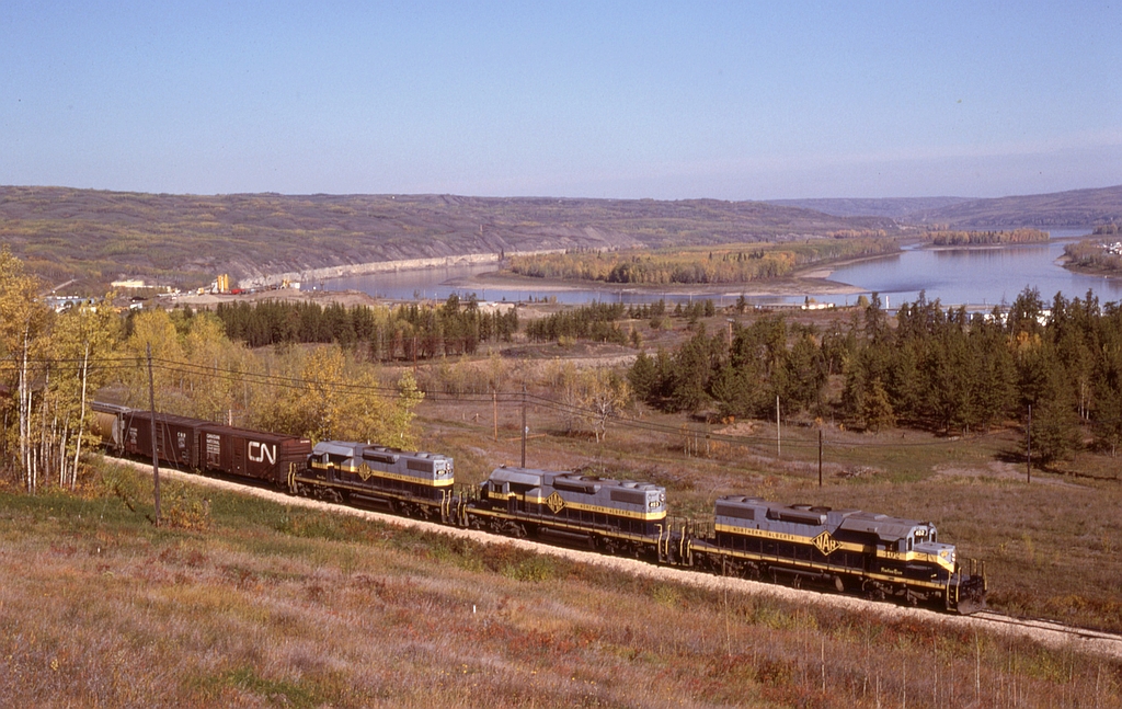 The homeward-bound (southward) GSL Turn on Saturday 1980-09-27 is shown making excellent use of the dynamic braking on SD38-2 units 402 + 403 + 401 at mileage 50.5 as they descend the grade approaching the Peace River crossing and town of the same name, a perfect match of machine and task.