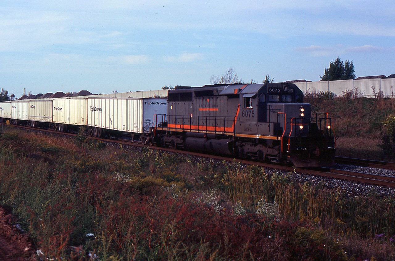 CN 145 with GCFX SD40-3 6075 at Tansley on the CN Halton Sub on Oct 3/2006