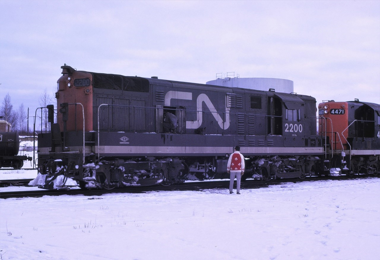 CN's first H-16-44, 2200, was having a temper tantrum on a cold December 1966 morning and did not want to start. The mechanic was making adjustments as the Road Foreman provided encouragement.  CN had a total of 18 of these FM designed units which were built by Canadian Locomotive Company in Kingston, Ontario in 1955.