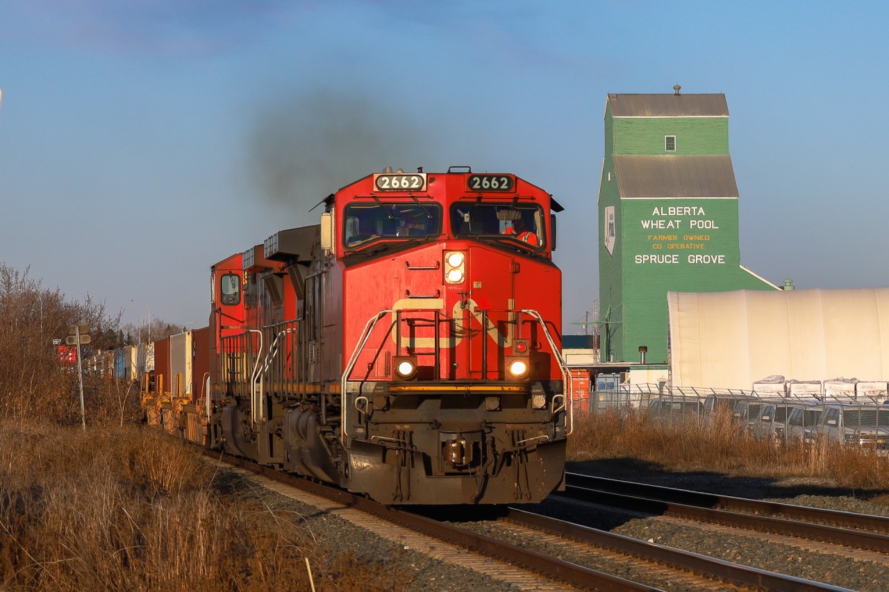 Montreal to Vancouver Q 10521 26 blasts past the grain elevator turned museum in downtown Spruce Grove.